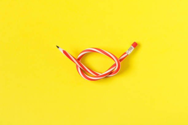 istock Red and white flexible pencil. Isolated on yellow background. 1125316552