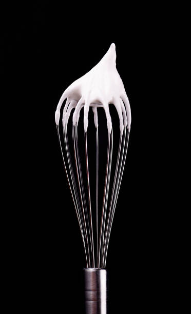 istock Metal whisk with whipped egg whites, isolated on black background. Clipping path. 1125316844