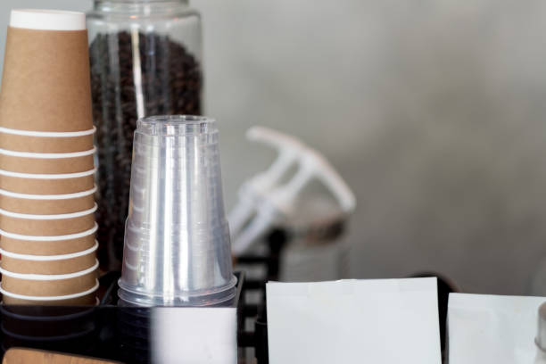 istock Rows of upside down transparent plastic cup and brown cardboard cups. As background coffee menu concept with copy space. 1125317568