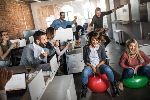 istock Cheerful colleagues having fun during space hopper at corporate office. 1125318335