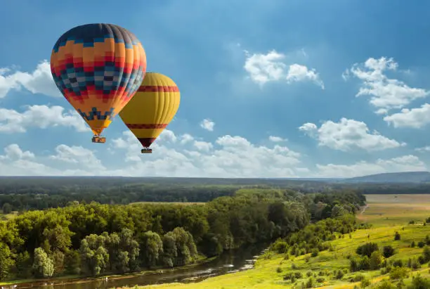 Photo of Colorful hot air balloon flying over green field
