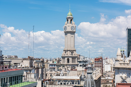 Upper view of a tower with a clock pf the Palace of the Buenos Aires City Legislature building at Montserrat district in downtown Buenos Aires, Argentina.