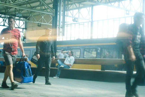 Travellers and commuters ready to board a  (Nederlandse Spoorwegen) NS train at Eindhoven railway station, the Netherlands. NS is a Dutch state-owned company, the principal passenger railway operator in the Netherlands. Founded in 1938, the Dutch rail network is the 7th busiest in the European Union, and 16th busiest in the world