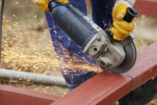 Worker grinding metal close up shot