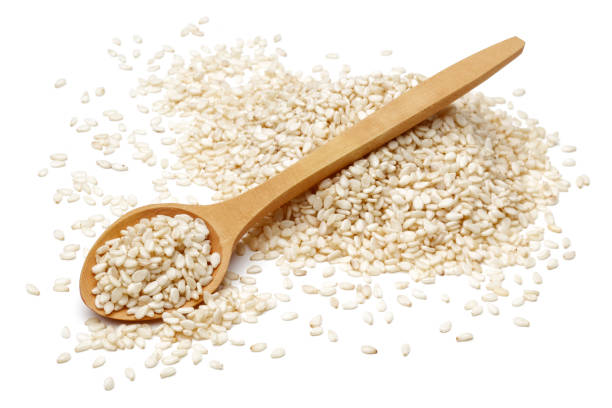 white sesame seeds and wooden spoon - sesame seed spoon scoop imagens e fotografias de stock