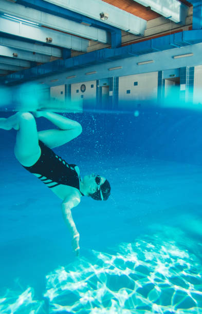 istock Young woman in pool and synchronized swimming. 1125338066