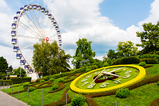 Geneva, Switzerland - August 24, 2018: The flower clock and Ferris Wheel in Geneva, Switzerland.