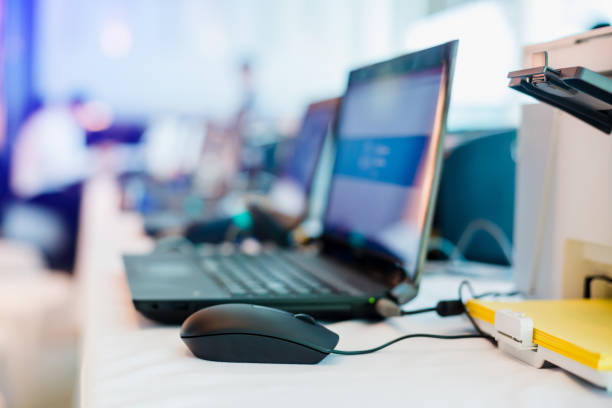 istock mouse and laptop with yellow paper in printer for staffs are typing information with barcode reader for register 1125338748