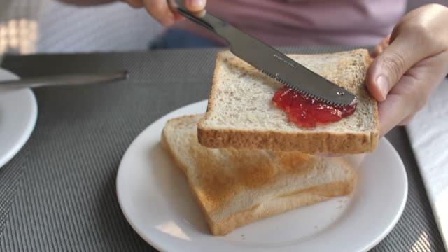 Spreading Jam on a slice of bread