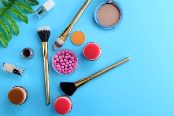 istock Makeup products with cosmetic bag and macaroons on light background 1125340395