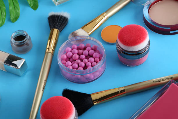 istock Makeup products with cosmetic bag and macaroons on light background 1125340626