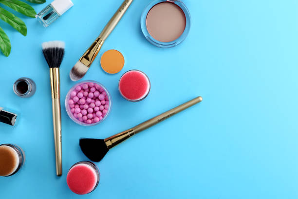 istock Makeup products with cosmetic bag and macaroons on light background 1125340868