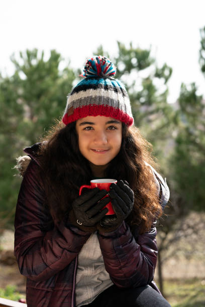 istock smiling girl at forest in winter 1125344965