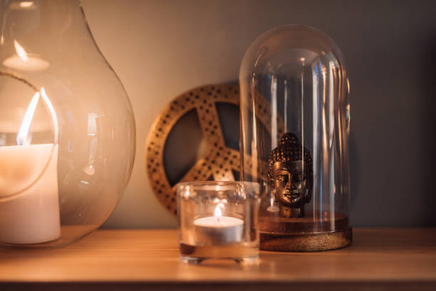 istock Cozy home interior shelf with candles and buddha 1125345538