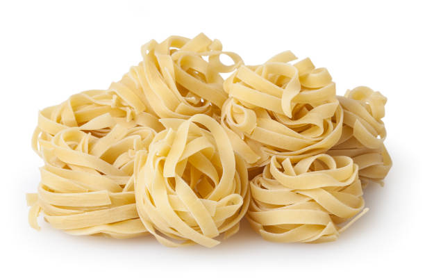 istock Uncooked nests of tagliatelle pasta isolated on white background with clipping path 1125349192