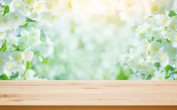 Photo of Empty table on blurred floral background