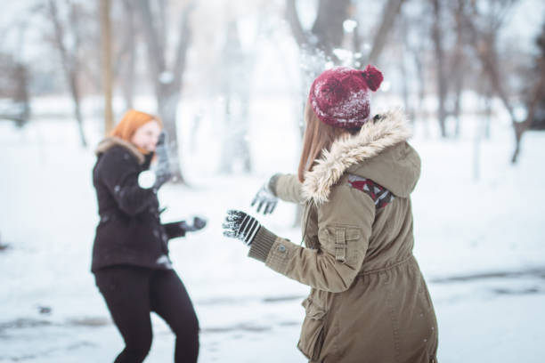 istock Girls having fun in the snow 1125349872