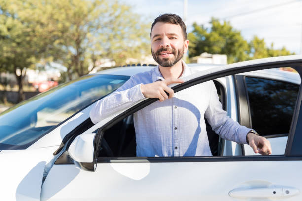 istock Latin Man Getting In Car On Sunny Day 1125351803