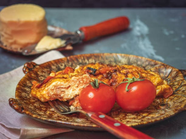 Breakfast with scrambled eggs and cheese. Plate shot close-up side.