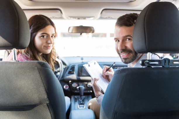 istock Woman And Instructor In Car During Test 1125353516