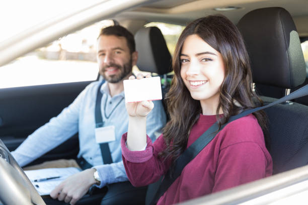 istock Woman In Car Showing Off Her Learning License 1125353604