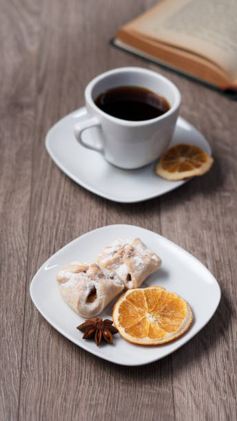Cup of coffee with book on wooden table