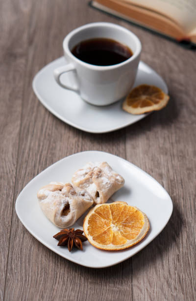 Cup of coffee with book on wooden table