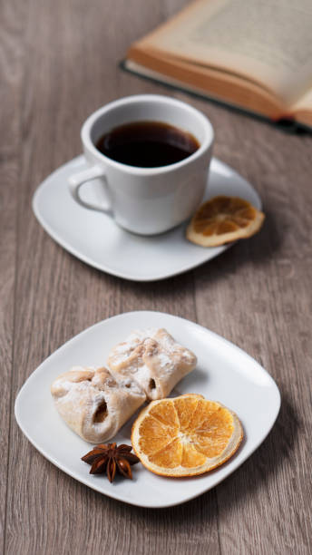 Cup of coffee with book on wooden table