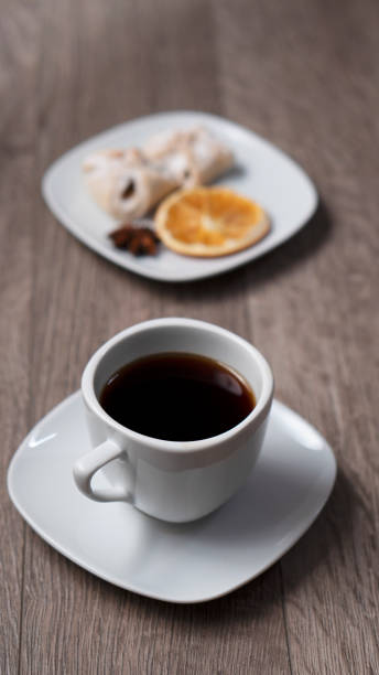 Cup of coffee with book on wooden table