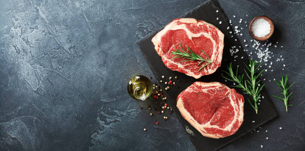 istock Fresh meat top view. Raw beef steak and spices for cooking. 1125357218