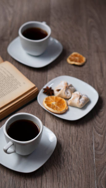 Cup of coffee with book on wooden table