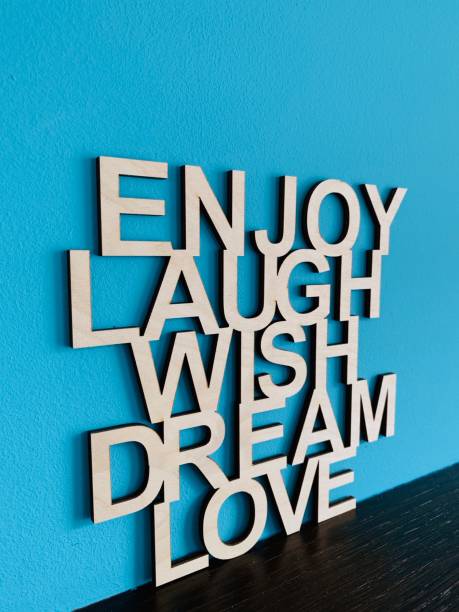 istock Encouraging text on blue background: enjoy, laugh, wish, dream, love 1125357629