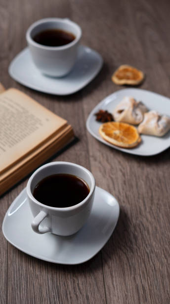 istock Cup of coffee with book on wooden table 1125357641