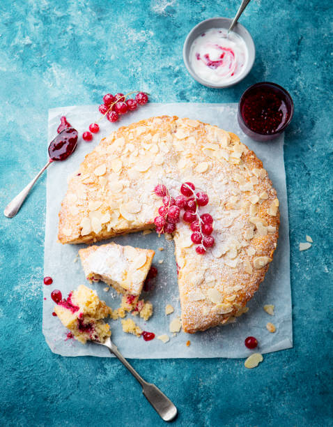 Almond and raspberry cake, Bakewell tart. Traditional British pastry. Blue background. Top view. Almond and raspberry cake, Bakewell tart. Traditional British pastry. Blue background. Top view bakewell photos stock pictures, royalty-free photos & images