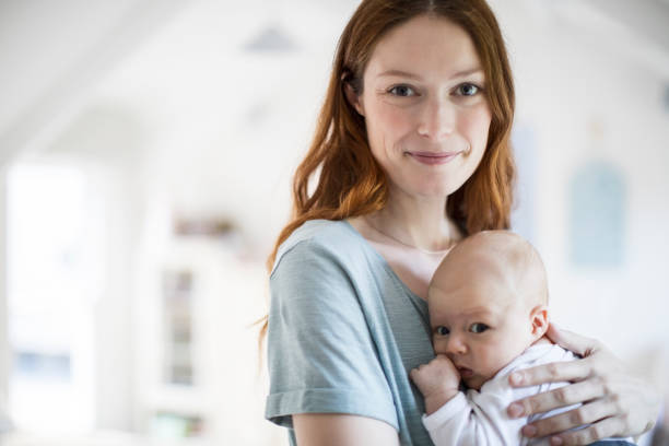 istock Smiling beautiful mother carrying son at home 1125359215
