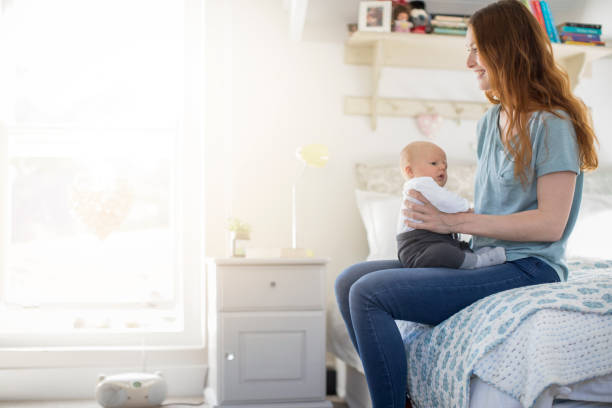 istock Happy redhead mother sitting with son on bed 1125359261