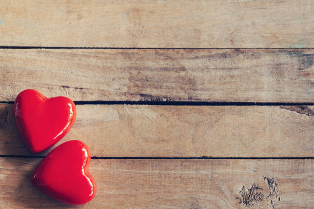 istock two red heart on wood table background with copy space 1125359411