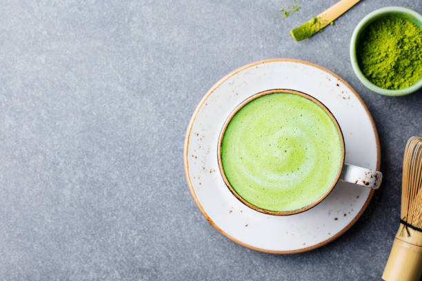 matcha green tea latte in a cup. top view. copy space. - latté imagens e fotografias de stock