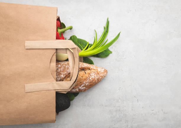 top view paper bag of different fresh health food - papel de pão imagens e fotografias de stock