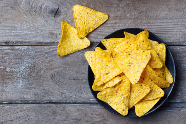 nachos, corn chips on black plate. wooden background. top view. copy space. - wood chip fotos imagens e fotografias de stock