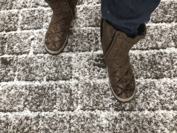 istock walking on a cobblestone street under snow in winter 1125362758