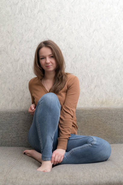 istock girl sitting on the couch 1125363456