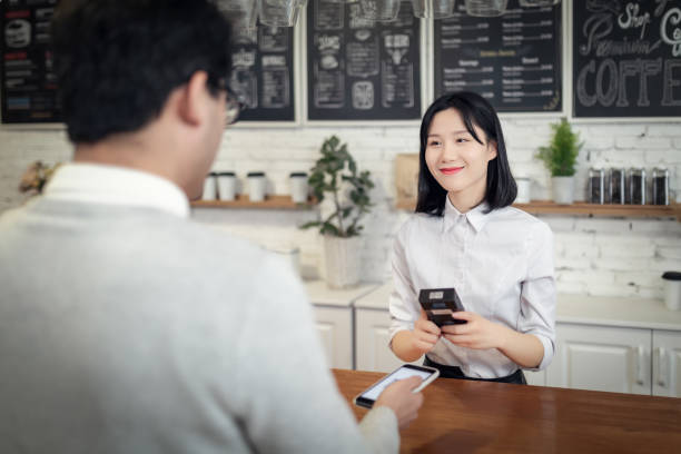 Paying with Smartphone in a Cafe Mobile Phone,Technology,Bar Counter, Payment, asian cashier stock pictures, royalty-free photos & images