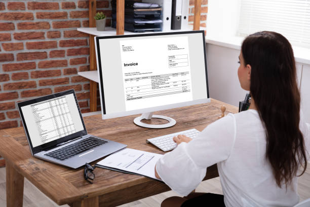 istock Businesswoman Checking Invoice On Computer 1125365624