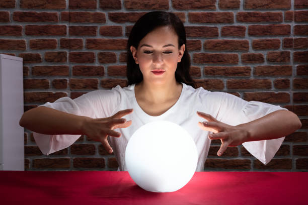 istock Woman Predicting Future With Crystal Ball 1125365675
