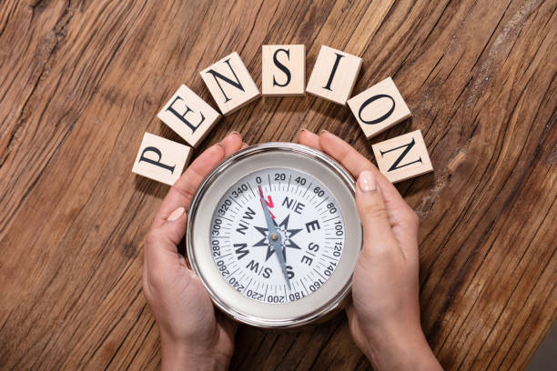 istock Hand Holding Compass Surrounded With Pension Blocks 1125365786
