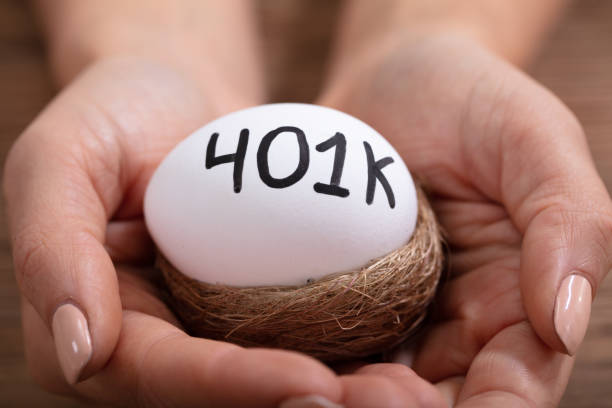 istock Human Hand Holding 401k Egg In Nest 1125365803