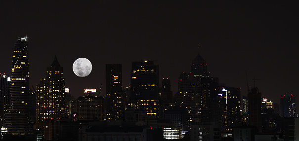 Landscape or cityscape of bangkok night view with super moon in the sky for background