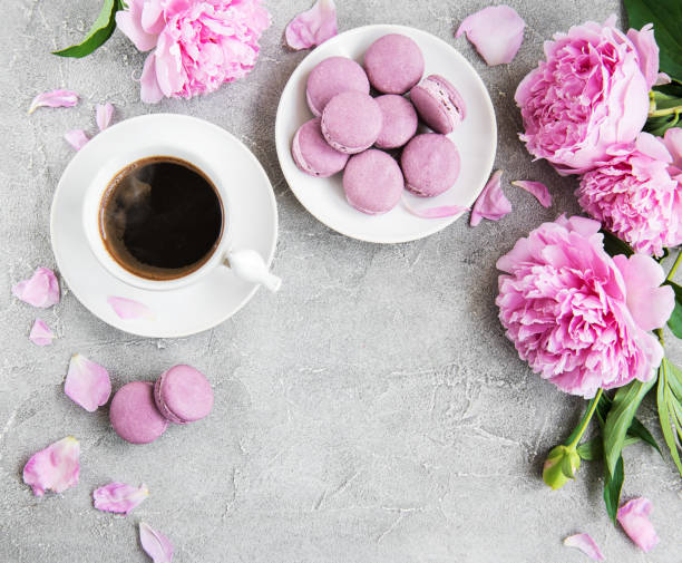 istock Pink peony with coffee and macarons 1125369468