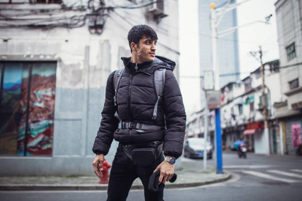 istock Young man with backpack walking on the street 1125372911